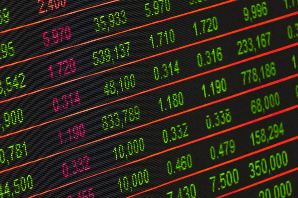 Close-up of a digital stock market data display showing colorful financial numbers and trends.